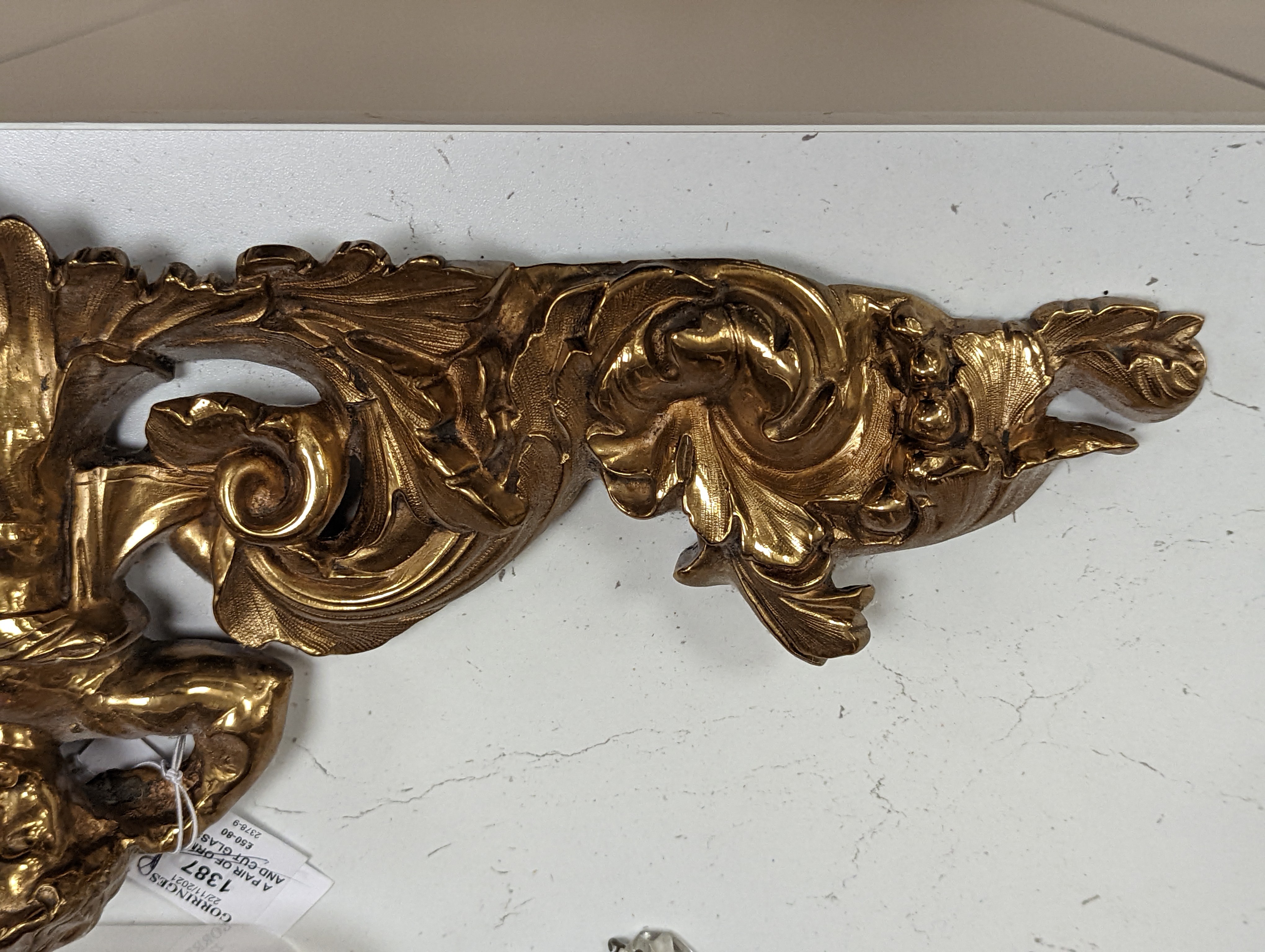 A pair of ormolu and cut glass twin branch wall lights, a bag light and a brass mount